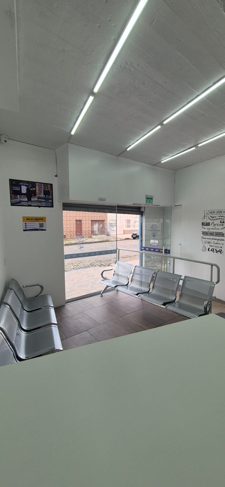 Espaço interno com TV, entrada e bancos